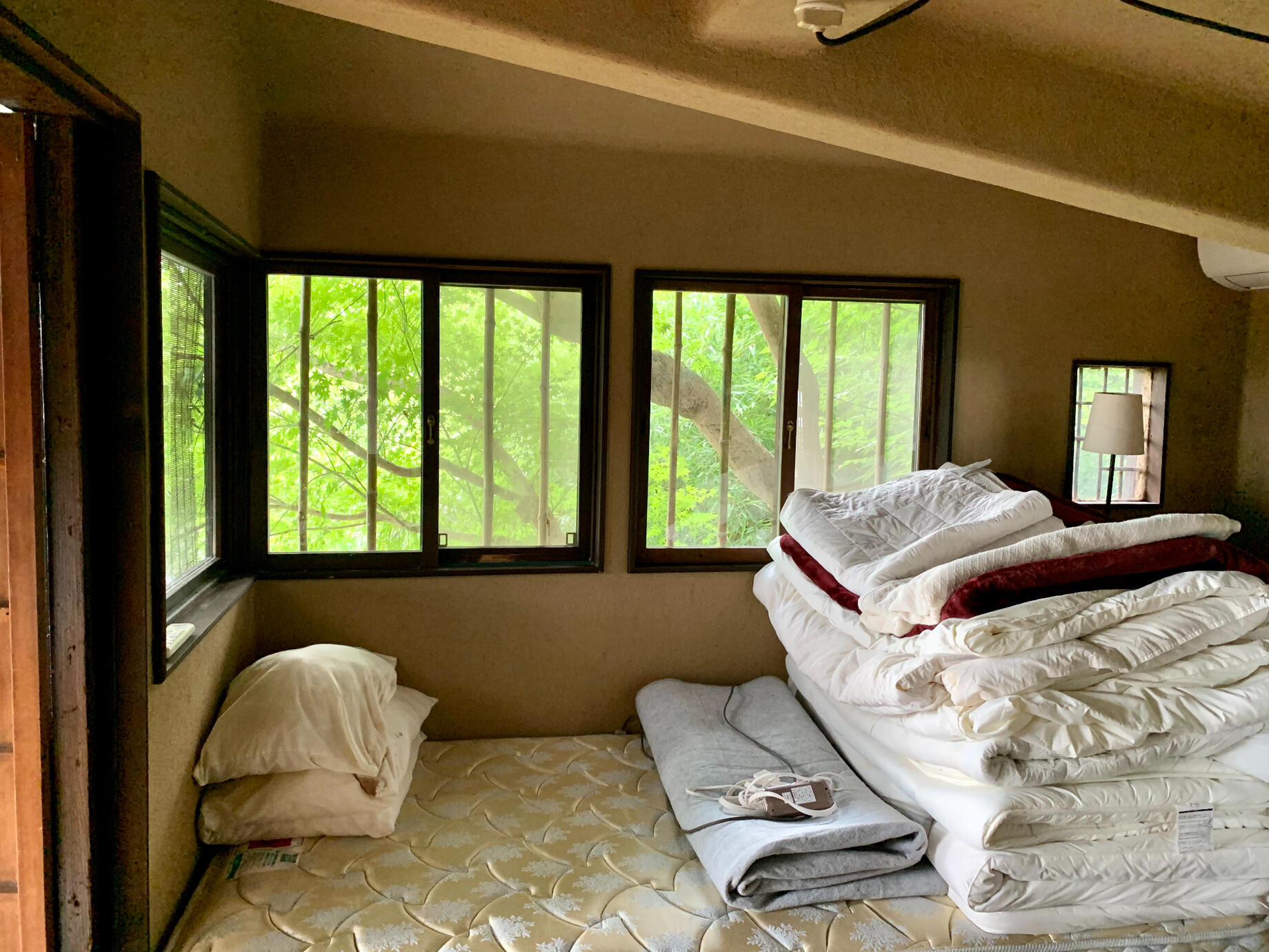 The cozy bedroom offers a western-facing view of Arashiyama sunsets and Japanese maple foliage.